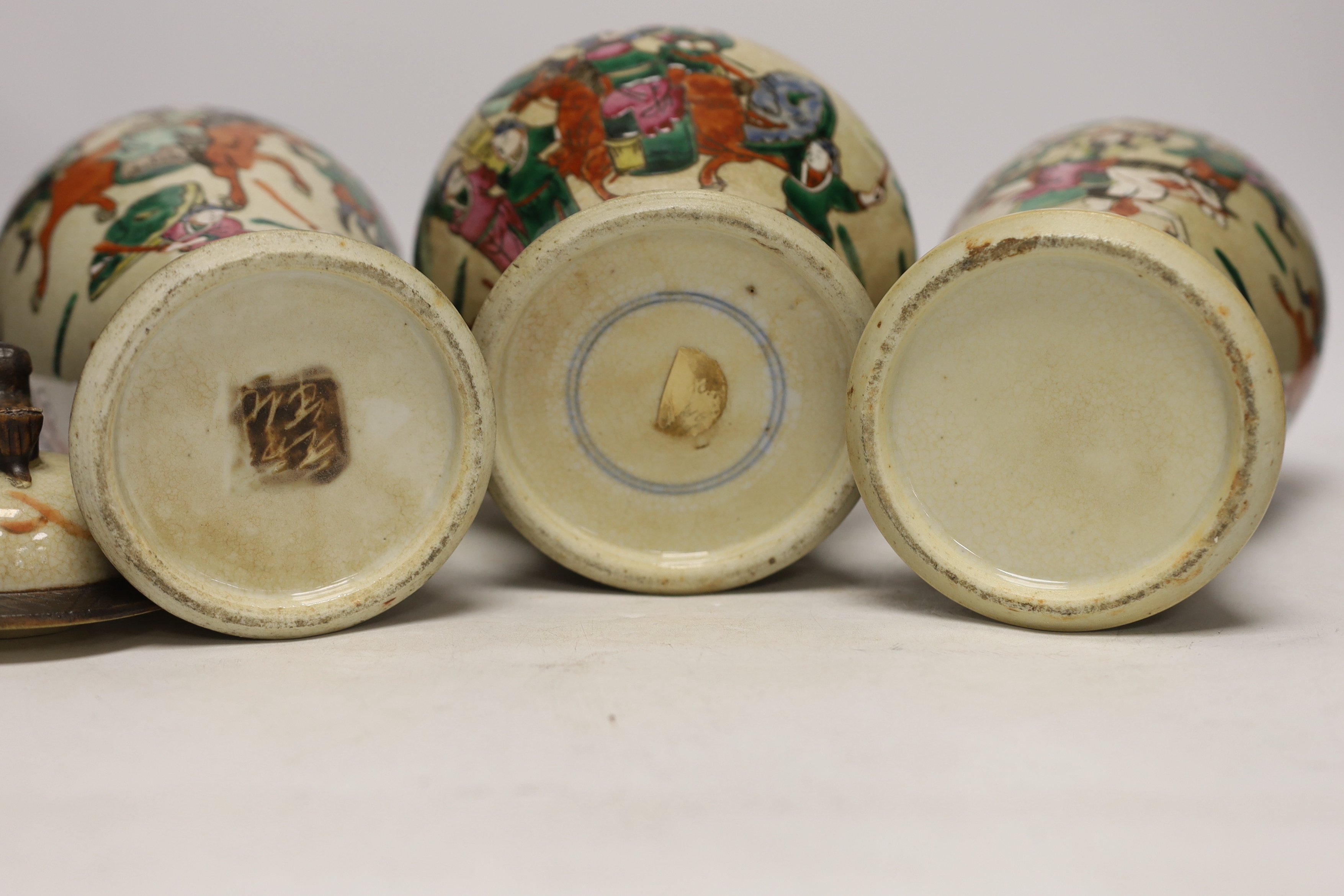 Three various Chinese crackleware famille rose jars and covers including a baluster example, largest 35cm high